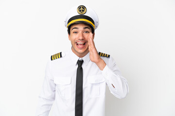 Airplane pilot over isolated white background shouting with mouth wide open