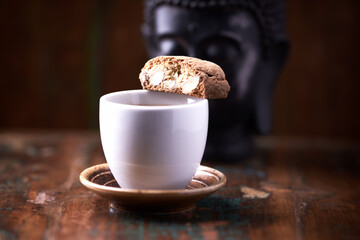 Cantuccini (Italian cookie) and a Cup of coffee on dark wooden background. Copy space	
