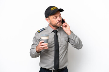 Middle age security man isolated on white background holding coffee to take away and a mobile