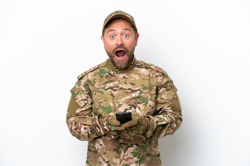 Military man isolated on white background surprised and sending a message