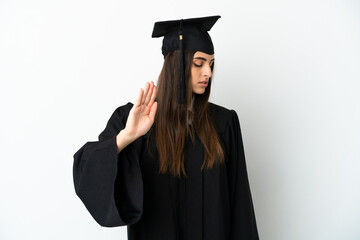 Young university graduate isolated on white background making stop gesture and disappointed