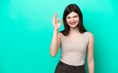 Fototapeta premium Young Russian woman isolated on green background showing ok sign with fingers