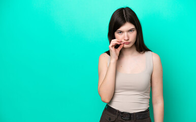 Young Russian woman isolated on green background showing a sign of silence gesture