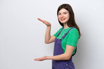 Young Russian woman isolated on blue background holding copyspace to insert an ad