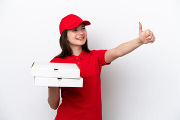 Young Russian pizza delivery picking up pizza boxes isolated on white background giving a thumbs up...