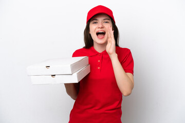 Young Russian pizza delivery picking up pizza boxes isolated on white background shouting with...