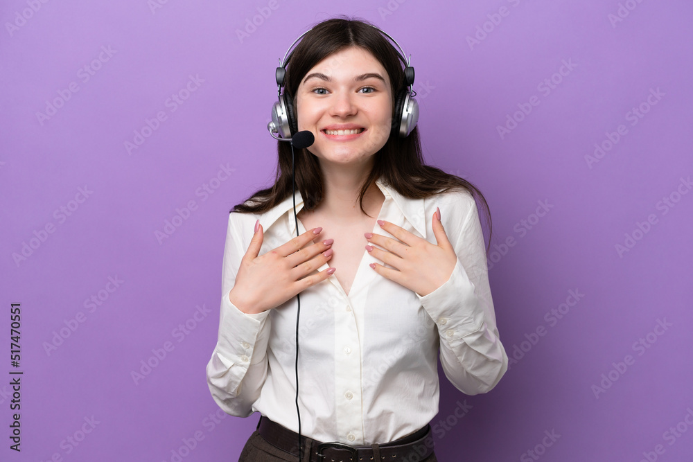 Wall mural Telemarketer Russian woman working with a headset isolated on purple background with surprise facial expression