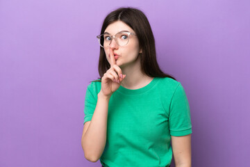 Young pretty Russian woman isolated on purple background With glasses and doing silence gesture