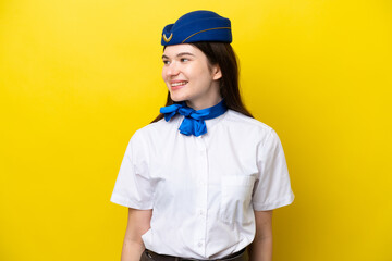 Airplane stewardess Russian woman isolated on yellow background looking side