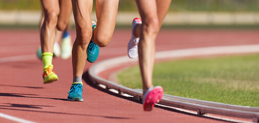 Athletics people running on the track field.Running a race on a track for sports competition and winning