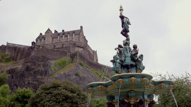 Edinburgh Scotland: 9th June 2022: the Ross Fountain in Princes Street Gardens with Edinburgh castle in background. ungraded log video