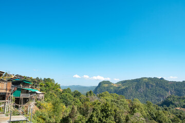 mountain scenery with wooden house on the edge of the hill