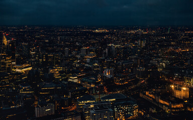 Aerial view of north east London, just after dark, orange yellow street lights starting to glow