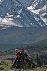 couple hugging in mountains landscape, romance happiness adventure together active