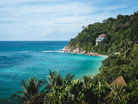 Scenic high angle view of Sai Daeng Beach, Koh Tao Island tropical paradise. Rocky coastline and clear turquoise sea with coral reef transparent water against summer blue sky. Surat Thani, Thailand.