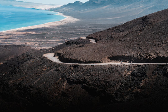 cyclists going up the Camino towards the beach of Fuerteventura, Cofete