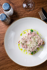 Steak Tartare with bread toasts served on plate. Food a restaurant.