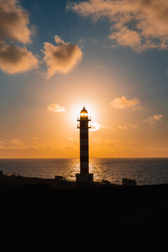 Vertical photo of a sunset at the Faro de Sardina, Galdar, on the island of Gran Canaria