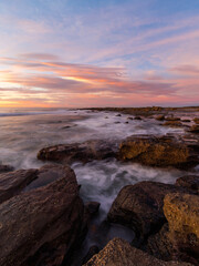 Fototapeta na wymiar Colorful sunrise view at rocky coastline.