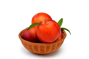 Fototapeta na wymiar peaches nectarines in a basket isolated on white background