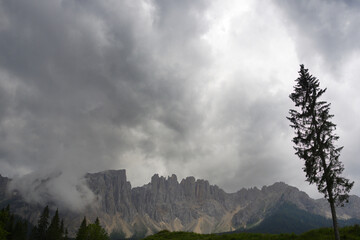 Fassa Valley, Italy, clouds over Dolomites mountains