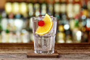 Fotobehang Refreshing cocktail tom collins on the bar counter © alexshyripa