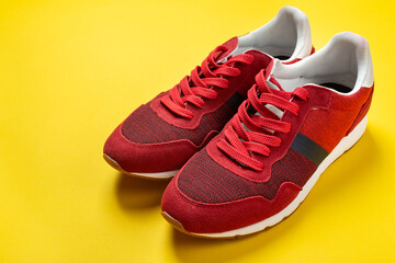 New red sneakers on a yellow background. space for text.