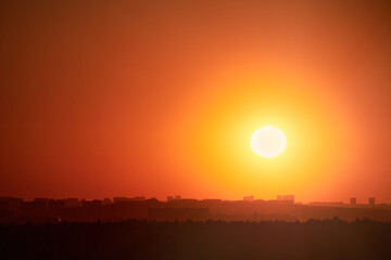Evening sky with setting sun through clouds at sunset, cloudy landscape