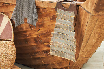Medieval vintage armor and retro chain mail of a warrior on board a ship. Reconstruction of the...