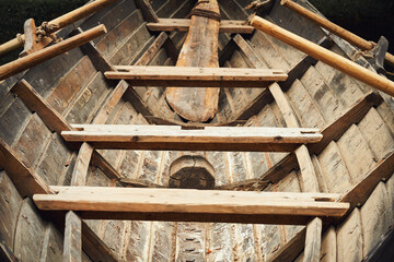 Medieval wooden ship on oars. Reconstruction of the events of the Middle Ages in Europe.