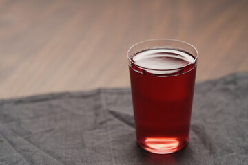 berry drink in thin glass on wood table with copy space