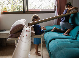 Child playing at home with cardboard, using his imagination and creativity