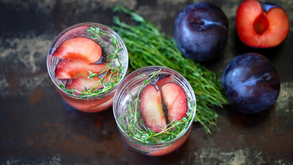 Detox drink with thyme and plum. Refreshing summer cocktail.