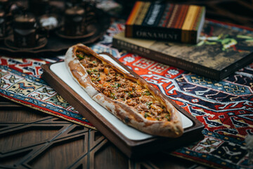 Pizza with meat and vegetables, Azerbaijani cuisine. Photography against a dark background