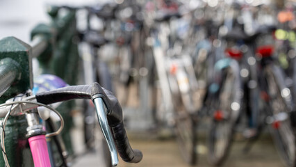 Obraz premium Many bicycles standing on a canal in Amsterdam - selective focus
