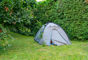 Small grey tent in garden close up