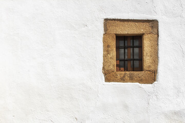 Old closed window on a white wall. Image with copy space