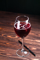 cocktail with red wine and ice, red cold summer alcoholic cocktail in a wine glass