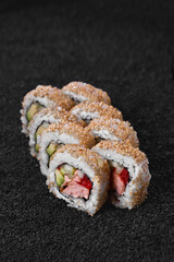 Sushi set from different rolls. Photo of food on a dark background.
