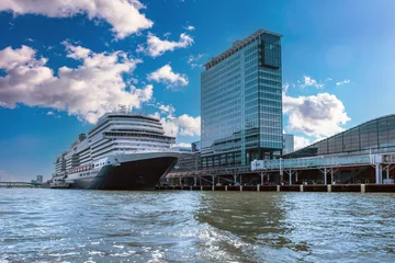 Papier Peint photo Amsterdam Amsterdam harbor. Line Cruise Ship docked at Holland Netherlands terminal. Cloudy blue sky