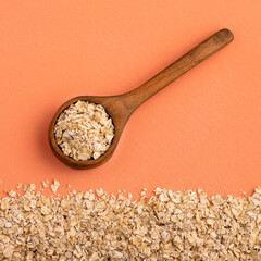 Avena sativa - Oat flakes in the wooden spoon