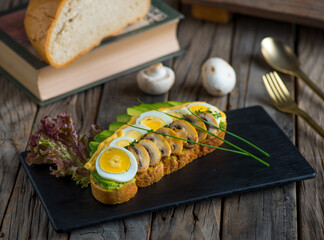avocado toast with mushroom and egg isolated on cutting board side view of breakfast on wooden background