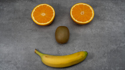 Happy smiling fruit face on stone background
