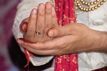 Indian wedding Rituals. Hindu Lagan Shaadi or wedding ceremony. selective focus on hand, background blur.
