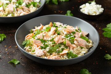 Salmon Couscous salad with feta cheese dressing and herbs. healthy food.