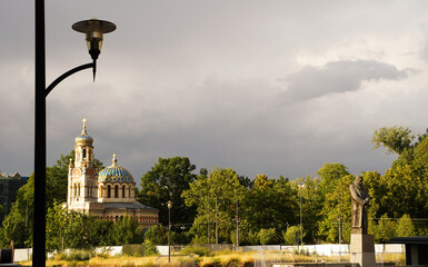 Wide angle shot of Marshal Jozef Pilsudski monument against church in Lodz during overcast, Poland - obrazy, fototapety, plakaty