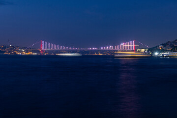 Panorama of Istanbul at night, long exposure with silky water and basques in movement, the Bosphorus bridge can be seen