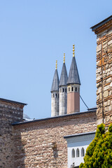 Fototapeta na wymiar Topkapi Palace towers that look like chimneys, in different colors, on a sunny day.