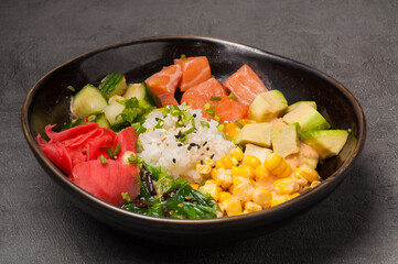 poke with salmon avocado in a dark plate