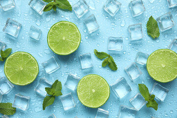 Ice cubes, mint and cut limes on turquoise background, flat lay. Ingredients for refreshing drink